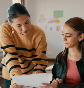 Female teacher talking to female student