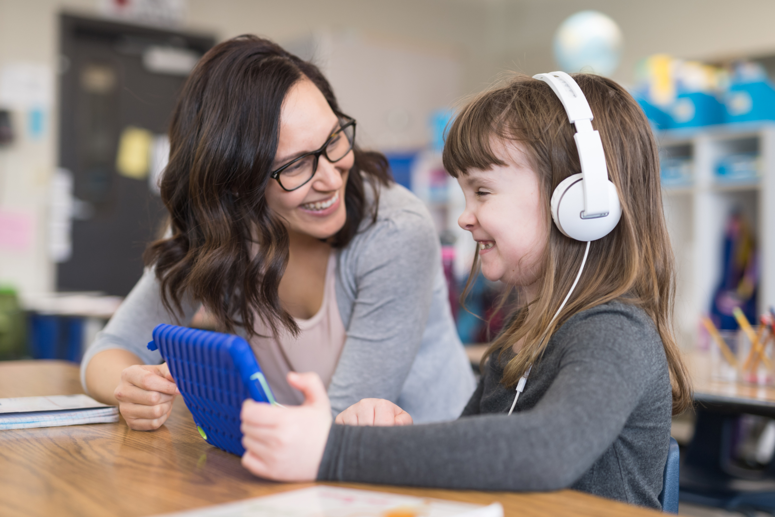 Teacher working with an elementary aged student who is hearing impaired