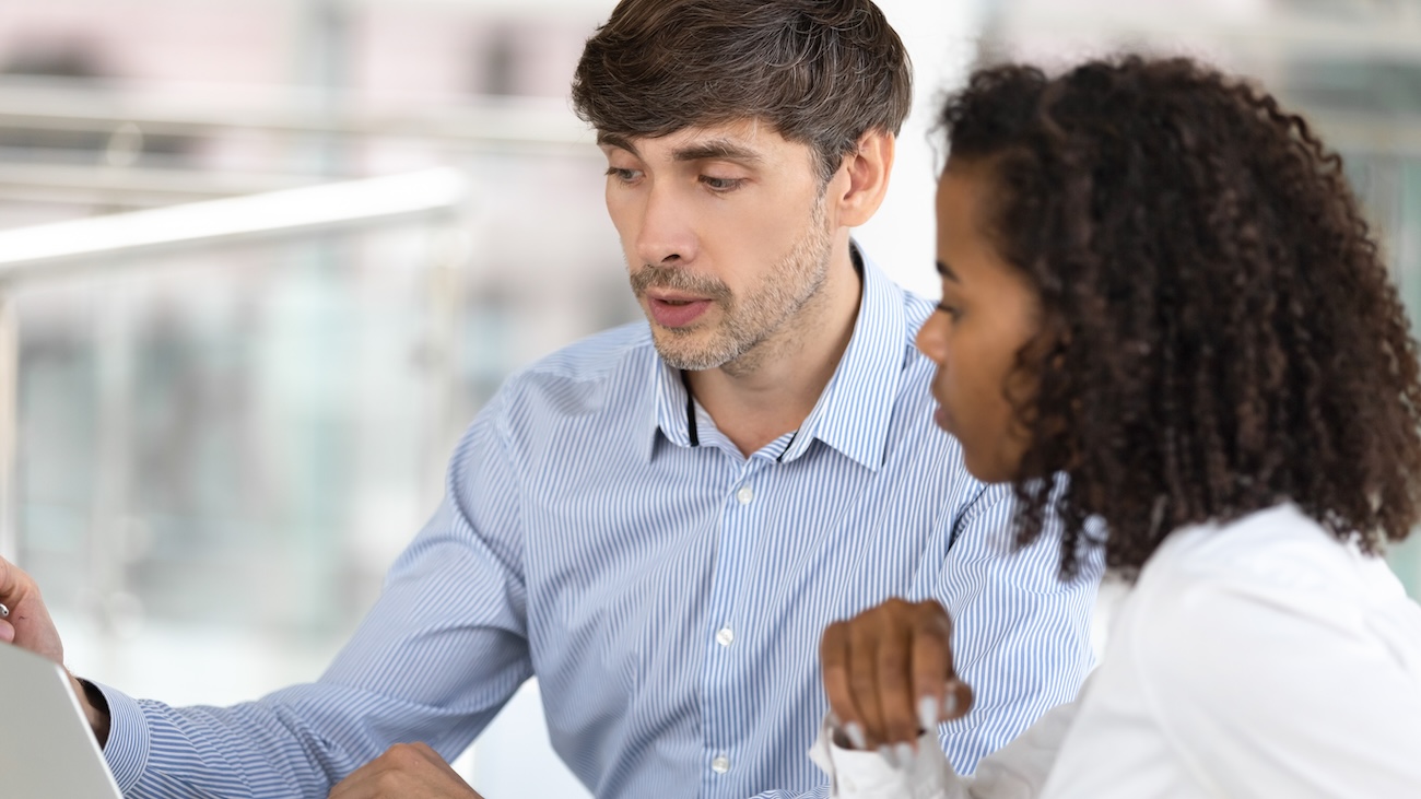 Male and female teacher discussing data